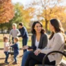 moms talking on a park bench while children play together nearby in a family-friendly community space